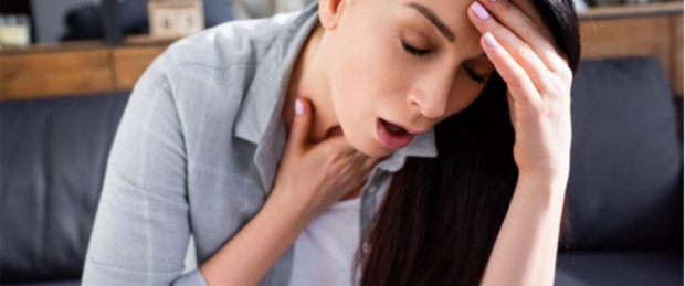 imagewqrew Woman experiencing heat exhaustion symptoms including dizziness and chest discomfort